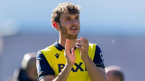 Stanley Mills applauds the Oxford United fans