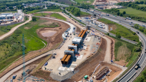  Aerial view a construction site by the side of a motorway
