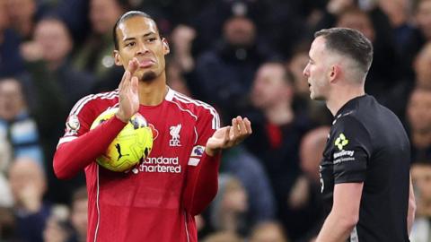 Liverpool defender Virgil van Dijk sarcastically applauds referee Chris Kavanagh