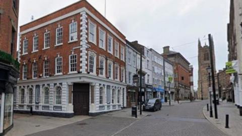 Street view of Iron Gate at the junction of Sadler Gate in Derby city centre.