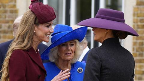 (l-r) Catherine, Princess of Wales,  Queen Camilla  talk with US First Lady Melania Trump  at Windsor Castle all wearing colourful hats 