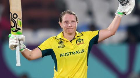Alyssa Healy raises bat and helmet to celebrate her century