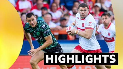 Hull KR's James Batchelor, wearing the Robin's white shirt, runs with the ball against Leigh Leopards