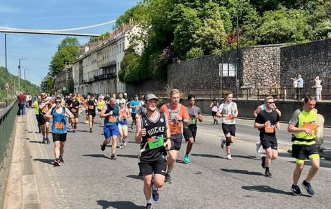 Runners near Clifton Suspension Bridge during Bristol's Half Marathon