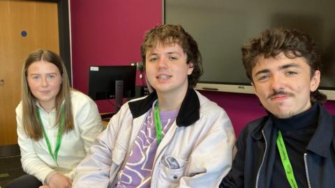 Three A-level students sitting in a classroom