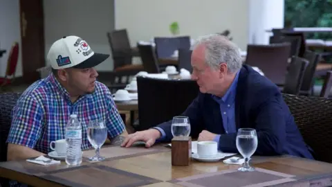Kilmar Abrego Garcia (L) speaks with Senator Chris Van Hollen (L)