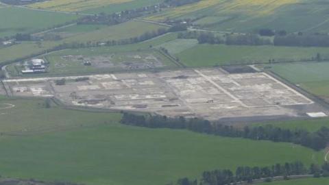 Aerial view of the former gas terminal surrounded by fields and trees