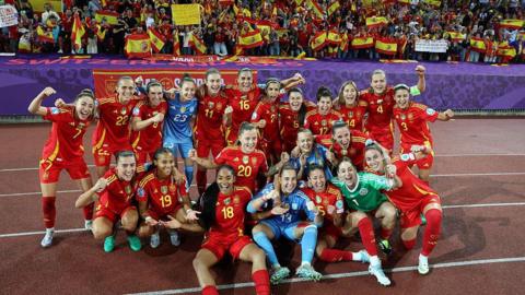 Spain's players pose for a photo following the team's semi-final victory against Germany. 
