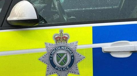 A close up image of a Lincolnshire Police car, focusing on the badge.