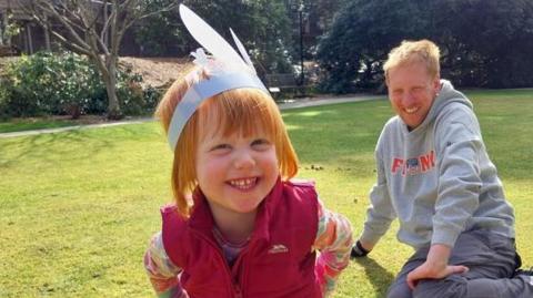 A family taking part on an Easter egg hunt