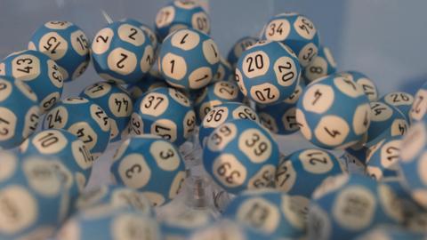 Lottery balls in a container awaiting a draw.