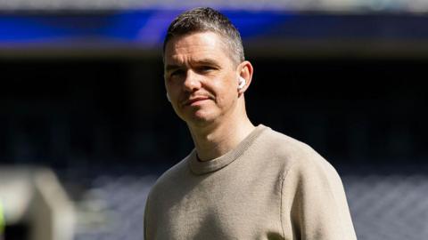 Close up image of Marc Skinner wearing in-ear headphones