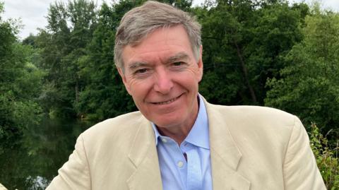 MP Philip Dunne in front of River Teme