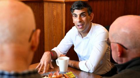 Rishi Sunak wearing a white shirt