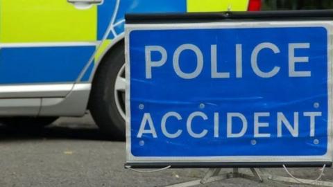 Stock image of a Police Accident sign and a police car