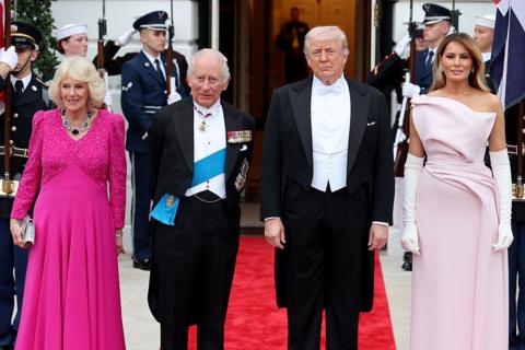 Queen Camilla, King Charles III, U.S. President Donald Trump, and First Lady Melania Trump pose at the base of the Grand Staircase during an official state dinner hosted by the President and First Lady at The White House on day two of the State Visit