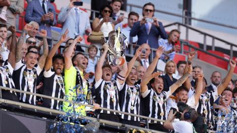 Notts County captain Matt Palmer lifting the League 2 play-off final trophy at Wembley.