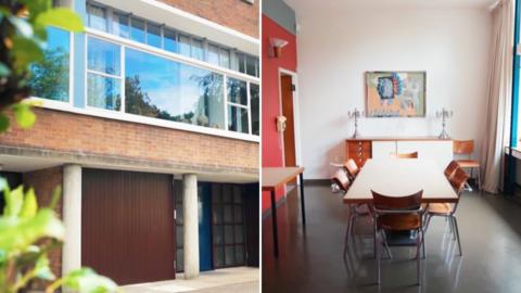 A brick building with large rectagonal windows and the inside of a kitchen with a table and chairs and artwork on the walls.