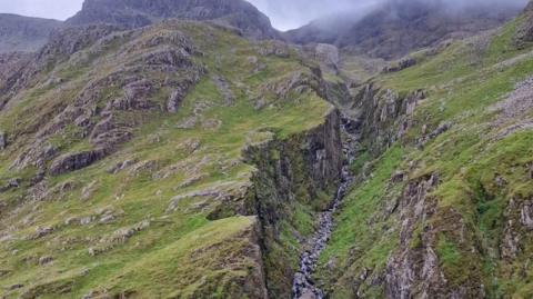 The view of Piers Gill with Scafell Pike in the background