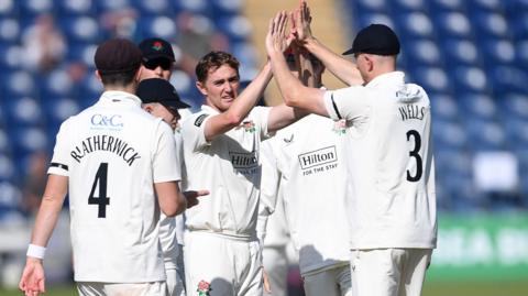 Lancashire celebrate as Colin Ingram is bowled out by George Balderson 