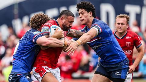 Elliot Minchella of Hull KR is tackled by Ky Rodwell of Wakefield Trinity during the Betfred Super League round 13 match between Wakefield Trinity and Hull KR at DIY Kitchens Stadium in Wakefield.