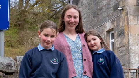 The teacher and two pupils outside Duror Primary in the Highlands.