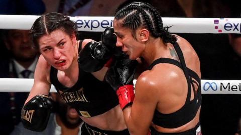 Katie Taylor punches Amanda Serrano during their fight