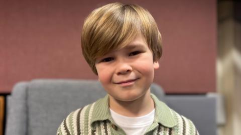 Fred sitting in a grey chair