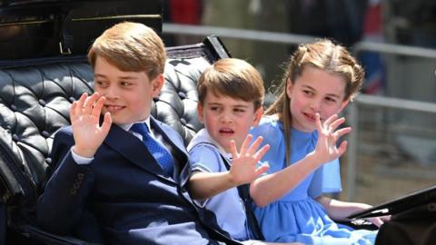 Prince George, Prince Louis and Princess Charlotte in a carriage in 2022