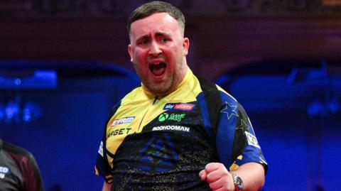Luke Littler celebrates his nine-darter at the Winter Gardens in Blackpool