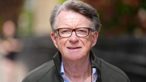 Peter Mandelson pictured walking his dog on Tuesday