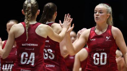 Alex Johnson (right) of Wales interacts with teammate Zoe Matthewman