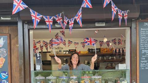 A woman with lots of Union flags. 