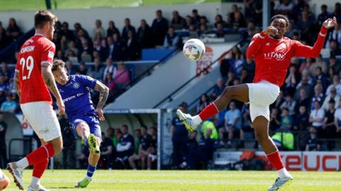 Rochdale's Luke Hannant takes a shot at goal against York