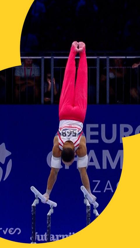 Joe Fraser upside-down during his bars routine