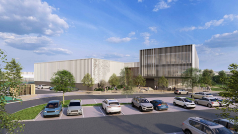 An artist's impression of the proposed leisure centre and council office from the front with large open windows and a large car park in the front.