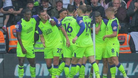 Preston players celebrate their goal at Derby County