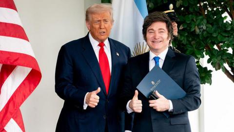 US President Donald Trump, left, and Javier Milei, Argentina's president, smile with their thumbs up outside the West Wing of the White House in Washington, DC, US, on Tuesday, Oct. 14, 2025, shortly after the US agreed to extend financial support for the Argentine peso.