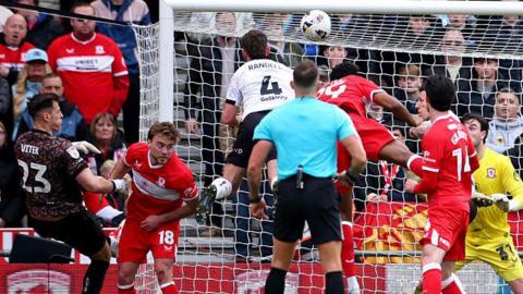 Bristol City midfielder Adam Randell powers home a header
