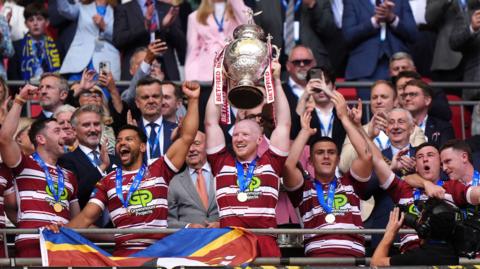 Liam Farrell lifts the Challenge Cup for Wigan