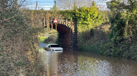 Car stuck in floodwater under railway bridge on Vaughan Road in Exeter