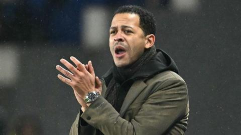 Strasbourg manager Liam Rosenior clapping in the dugout