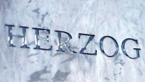 A close shot of a metal plaque saying Herzog