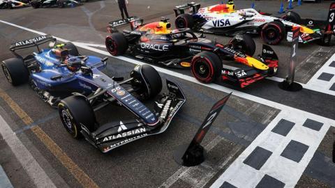 Carlos Sainz, Max Verstappen and Liam Lawson's cars lined up after qualifying 
