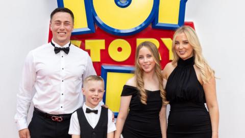 The family lined up for a photo in their formal clothes