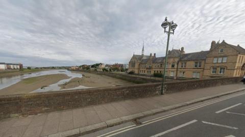 Barnstaple seen from Long Bridge. The River Taw is at low tide and from the bridge we can see the Bridge Chambers Business Centre, which appears to be Victorian in architecture.