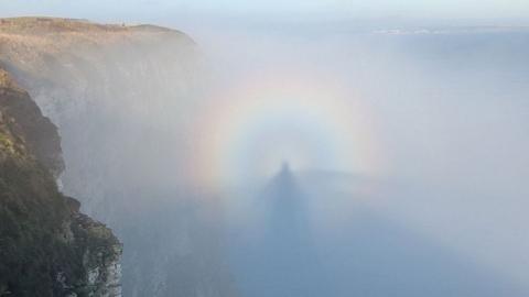 An image of a person's shadow in mist, encased in a rainbow, off Bempton Cliffs in East Yorkshire.