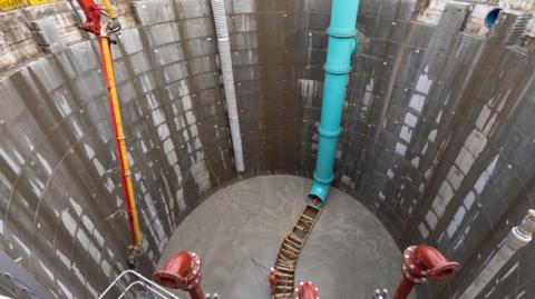 Vast underground storage tank under construction.