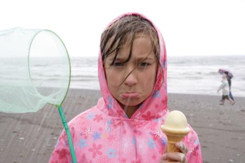 Girl wearing pink raincoat with flowers 