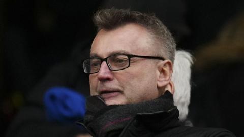 Craig Hemmings, wearing a scarf and coat, in the director's box ahead of a Preston match in December 2024